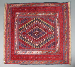 A red ground Gazark rug with stylised diamond to the centre within multi-row borders 47" x 44"