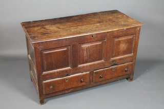 An early 18th Century oak mule chest with hinged top above a triple panelled front with 2 short drawers below, raised on end  stiles, 30"h x 49"w x 21"d