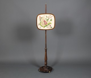 A 19th Century mahogany pole screen with embroidered panel on bun feet