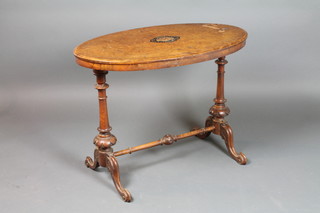 An oval Victorian figured walnut stretcher table, raised on turned supports with H framed stretcher 26"h x 35"w x 20 1/2"d