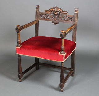 A carved oak Carolean style elbow chair with stuff over seat on turned legs