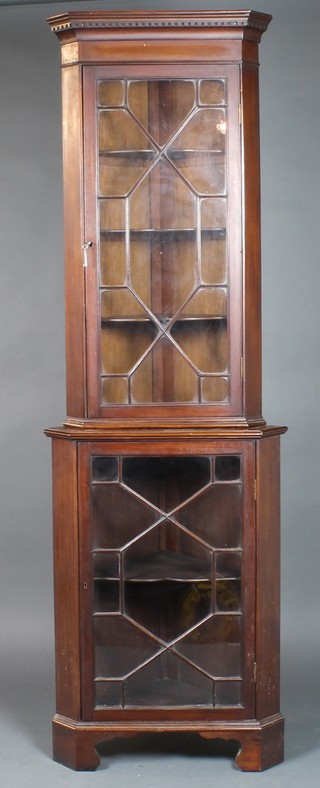 A 19th Century mahogany double corner cabinet with moulded and dentil cornice, each section fitted adjustable shelves enclosed by astragal glazed panelled doors,  78"h x 25"w x 15"d 