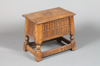 A rectangular oak joyned stool, the top with hinged lid and arcaded decoration, raised on turned and block supports 16"h x 11 1/2"w x 18"d 