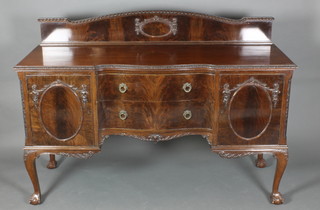 A Chippendale style mahogany sideboard with raised back and shaped outline, fitted 2 long drawers flanked by a pair of cupboards, raised on cabriole, ball and claw supports 46 1/2"h x 65 1/2"w x 24"d 