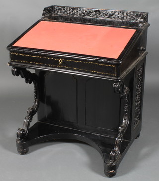 A Victorian lacquered Davenport desk with pierced three quarter gallery and red leather writing surface, the pedestal fitted an  inkwell and drawers 36"h x 29"w x 24"d