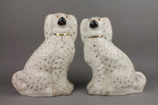 A pair of Victorian Staffordshire figures of seated Spaniels with gilt decoration 15"