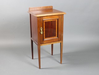An Edwardian inlaid mahogany bedside cabinet with raised back enclosed by a panelled door, raised on square tapered supports 32"h x 16"w x 15"d 