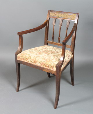 A Regency mahogany bar back open arm chair with dart decoration, raised on front and rear sabre supports 