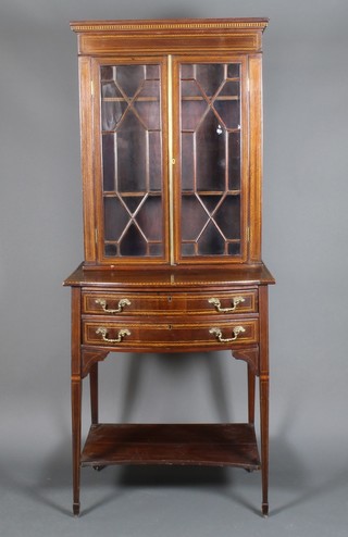 An Edwardian inlaid mahogany display cabinet with astragal doors above 2 bowed doors on square tapered feet 72"h x 30"w x 21"d