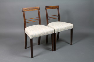 A pair of 19th Century inlaid mahogany bar back dining chairs with plain mid rails and upholstered seats, raised on square tapered supports 