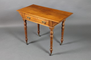 An Edwardian Art Nouveau rectangular walnut side table fitted a drawer, raised on turned supports 28"h x 36"w x 19"d 
