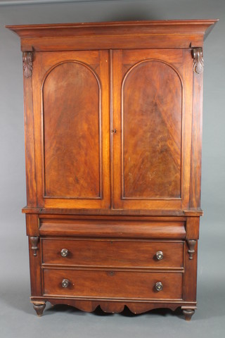 A Victorian mahogany linen press with moulded cornice, the interior fitted 2 shelves enclosed by a pair of arched panelled doors, the base fitted 1 long secret drawer above 1 long drawer with tore handles, raised on turned feet 88"h x 57"w x 23"d 