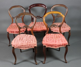 A set of 4 Victorian mahogany balloon back dining chairs with carved mid rails, the seats of serpentine outline raised on cabriole supports and 1 other