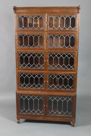 An oak Globe Wernicke style 5 tier bookcase enclosed by lead glazed panelled doors 69"h x 35"w x 11"d