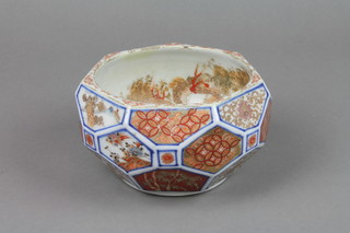 A 19th Century Imari bowl with faceted sides having panels of flowers, motifs and garden landscapes, the interior decorated with dragons 6" 