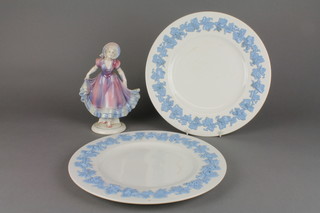 A Continental 1930's figure of a lady and two Wedgwood two colour plates