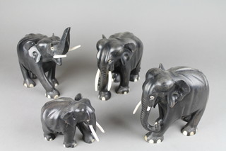 4 various ebony figures of elephants with ivory tusks 8" largest, smallest 4"