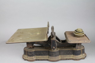A pair of Bartlett Bristol iron and brass scales complete with weights 