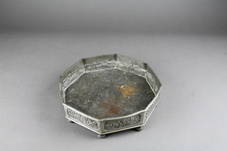 A Chinese octagonal pewter dish the body cast flowers and raised on 8 circular feet 9 1/2" 