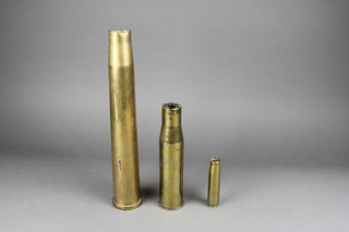 A 4/7 brass anti aircraft shell case, dated 1954, a 27mm brass shell case and a cannon shell case dated 1944 