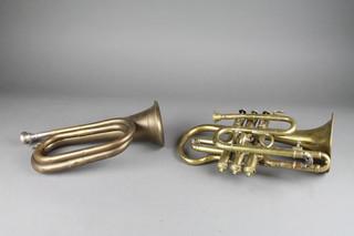 A brass bugle together with a brass cornet by R Delacy, the bell and body dentend 