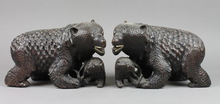A pair of carved hardwood figures of bears with cubs set hardstone eyes and ivory teeth 6" (one missing teeth and eye)