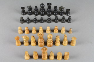A turned ebony and light wood chess set, missing 2 pawns together with a turned wooden king, 2 castles, 2 turned bishops, turned pawn and an ebonised turned pawn 