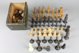 A 32 piece Staunton turned ebonised and light wood chess set, missing 1 black pawn, 1 white pawn and a castle, 23 chess pieces comprising 8 turned white wood pawns, castle, 2 rooks, king, queen, bishop and 1 other turned base together with 4 turned black pawns, castle, bishop, king and queen together with 28 various turned white wood dominoes and 16 turned black dominoes 