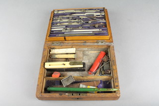 A 19th Century ivory and brass mounted quill cutter by Rodgers, an ivory 6" folding gauge, a steel geometry set contained in a box and a 6" gauge