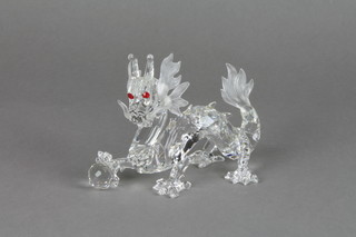 A Swarovski figure of a dragon holding a flaming pearl 6"