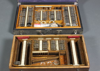 A quantity of various ophthalmic lenses and equipment contained in 2 carrying cases
