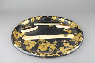 A Victorian oval black lacquered mother of pearl tray with relief decoration 17", 2 nail buffers etc