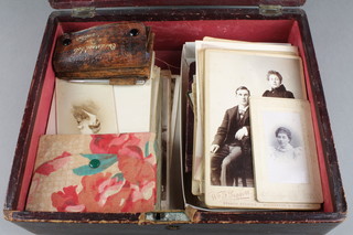 A Victorian red leather trinket box with hinged lid containing a collection of black and white photographs etc 