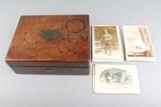 A 19th Century rectangular mahogany box with hinged lid containing a collection of black and white postcards 