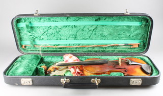 A 2 piece violin, bears label Joseph Aubry Le Havre 14 1/2" together with bow contained in a modern carrying case 
