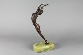 An Art Deco style bronzed figure of a standing girl with arms outstretched raised on an oval green marble base 14"