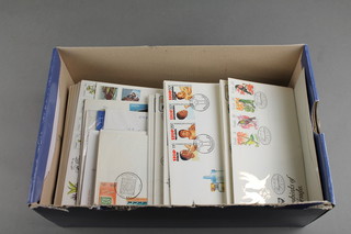 A shoe box containing a collection of various World first day covers 