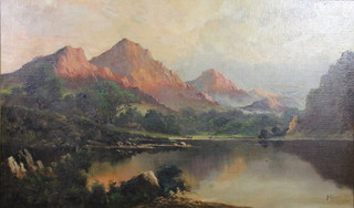 J M Tucker, oil painting.  An extensive sunset view of a lake side view with distant cattle and mountains, signed 29" x 50"