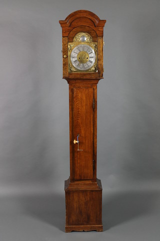A 17th Century style single handed longcase clock, the 9 1/2" brass arched dial with silvered chapter ring, contained in an oak case with sliding detachable hood 73 1/2"h 