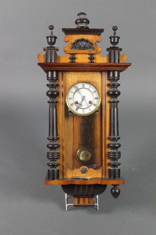 A Vienna style striking regulator with 5" circular dial contained in a walnut case with grid iron pendulum 