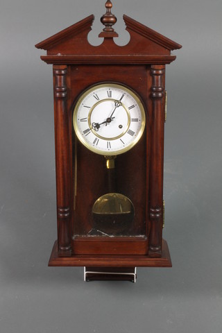 A chiming wall "regulator" with 6 1/2" enamelled dial and Roman numerals, striking on a gong, contained in a mahogany case