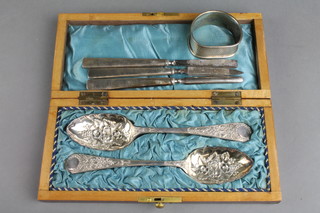 A pair of cased Edwardian plated berry spoons, 3 silver mounted manicure implements and a napkin ring