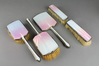 An Art Deco silver and guilloche enamelled brush set comprising 2 hair brushes, 2 clothes brushes and a hand mirror, Birmingham 1936 (f)
