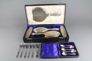 A cased 8 piece silver backed dressing table set with engine turned decoration and monogramme, 5 silver plated coffee spoons and a set of plated forks