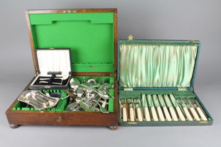 An oak canteen containing a quantity of mixed silver plated cutlery and 2 cased plated sets