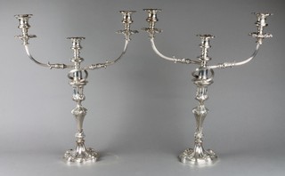 A pair of 19th Century 3 light silver plated candelabra decorated with scrolls and flowers on a waisted acanthus stem 20" 