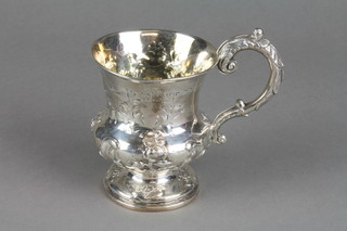 A Victorian silver baluster mug with acanthus S scroll handle, the repousse decoration with formal flowers and scrolls, London 1861, 3.5"