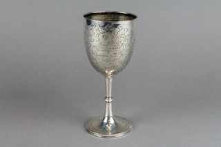 A Victorian chased silver goblet decorated with scrolling leaves and bearing an inscription with spread base, Sheffield 1891, 5.75 ozs