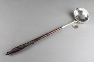 A Georgian punch ladle with coin set base and turned wood handle 15"