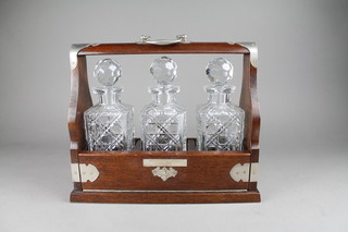 A modern mahogany and silver plated mounted 3 bottle tantalus with swing handle 14"